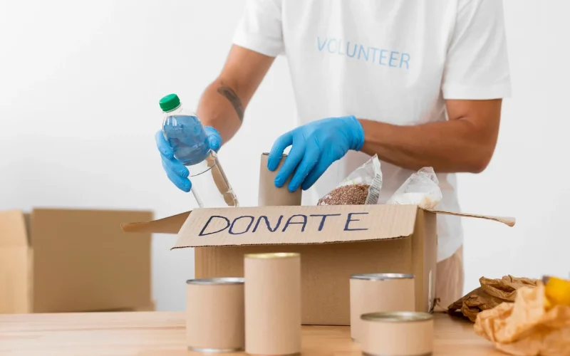 imgi_68_volunteer-placing-different-goodies-donation-boxes_23-2148687282